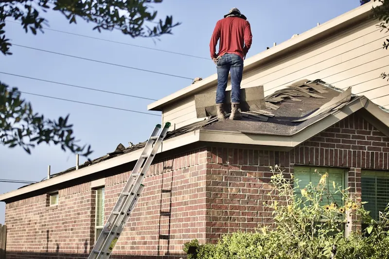 Professional roofer working on a residential roof in Wismer